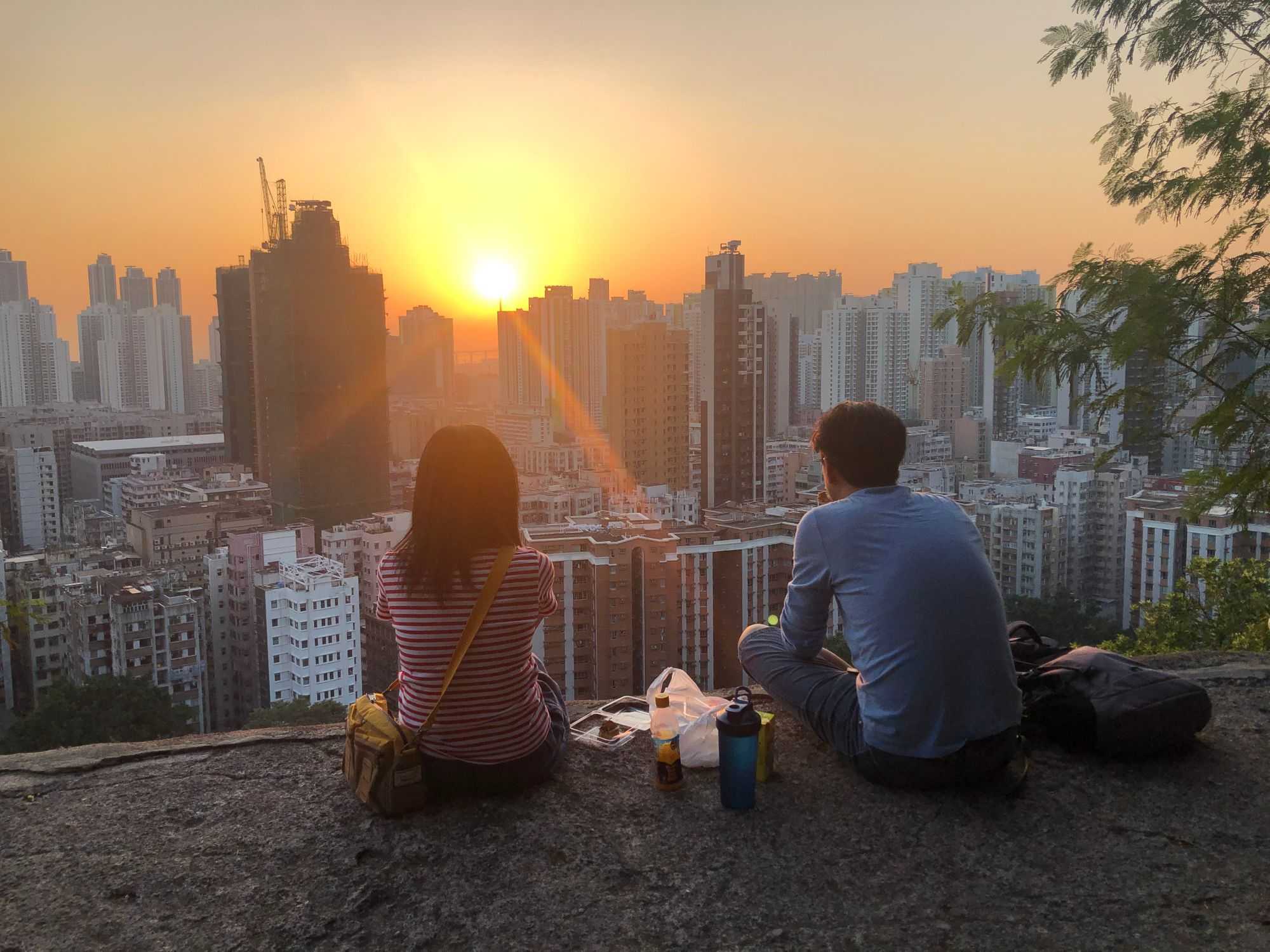 A couple watching the sunset at Garden Hill (Image by author)